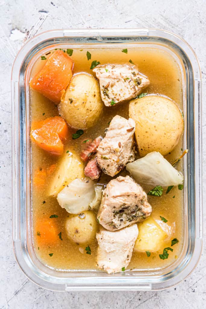 the irish chicken stew inside a glass meal storage container