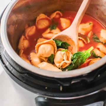 top down view of the finished instant pot chicken tortellini soup inside the instant pot