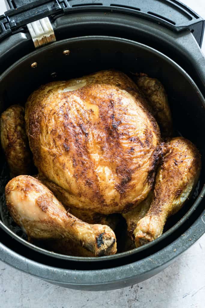 the finished whole chicken in air fryer basket