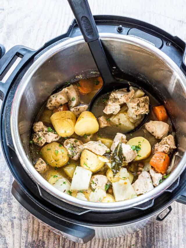 top down view of the completed irish chicken stew inside the instant pot with a ladle scooping out one serving