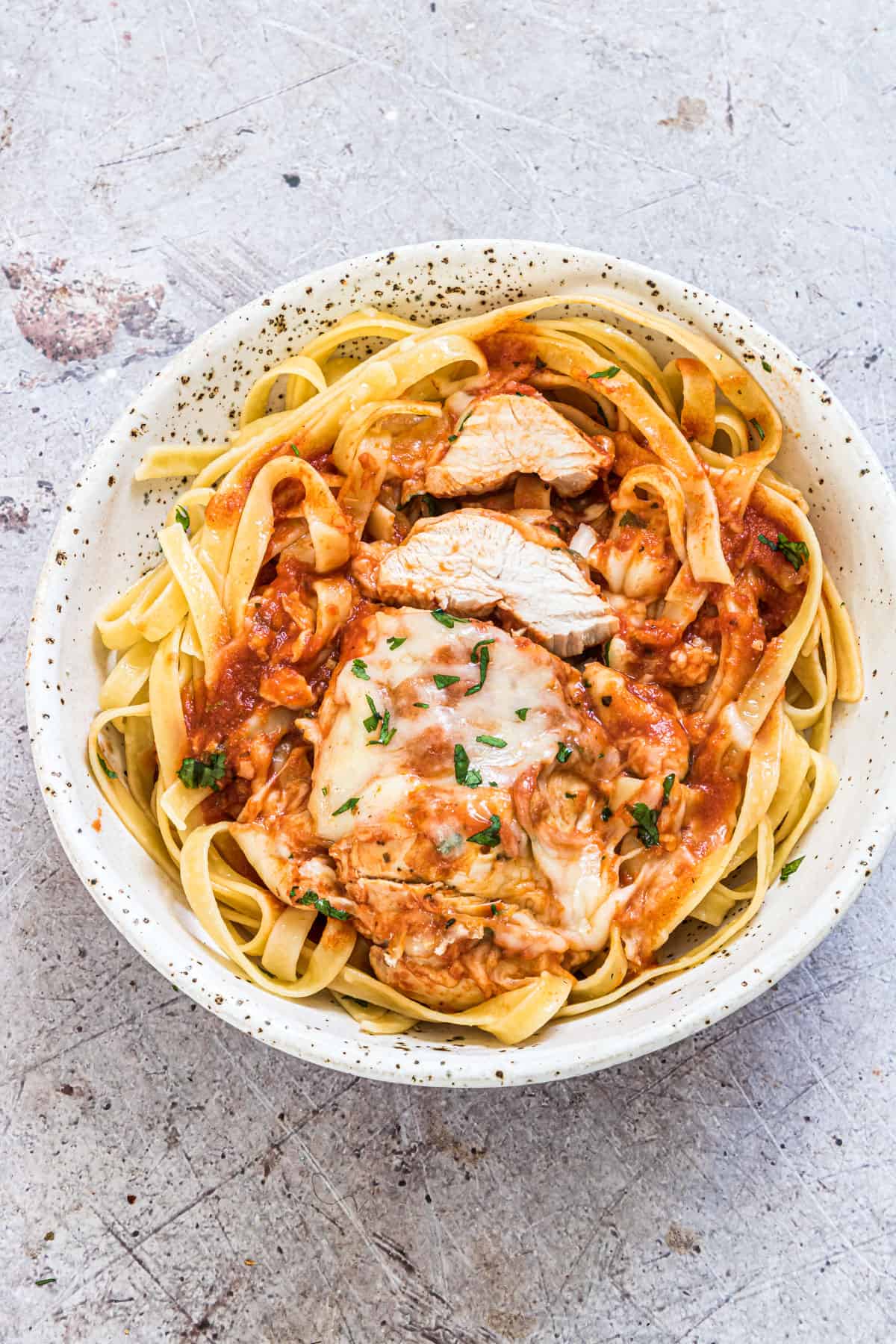 top down view of a serving of instant pot chicken parmesan over pastas noodles
