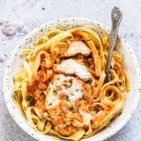 a bowl of instant pot chicken parmesan served on top of pasta
