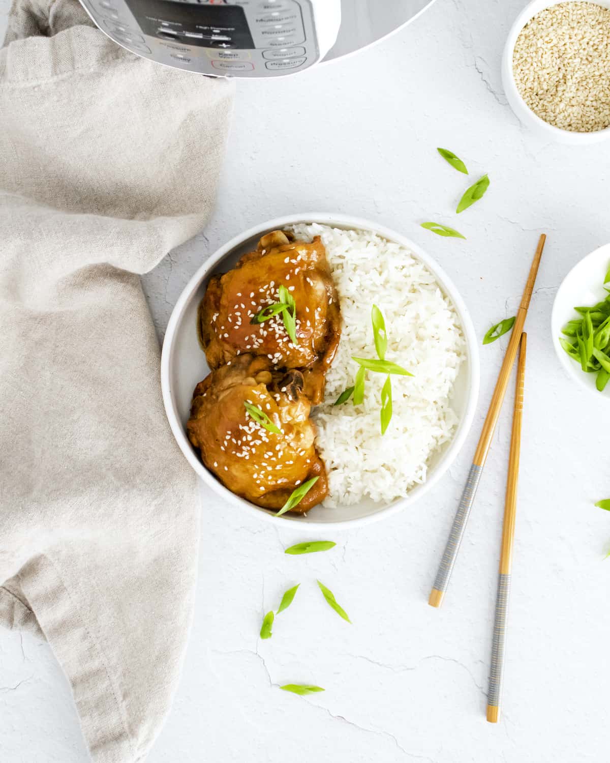the completed instant pot honey garlic chicken served in a bowl with rice
