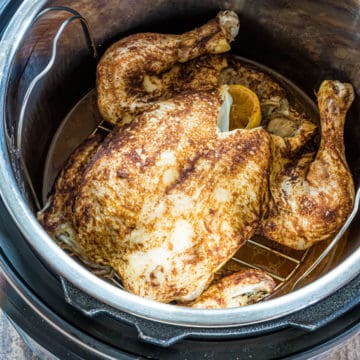 the finished whole chicken inside the instant pot insert