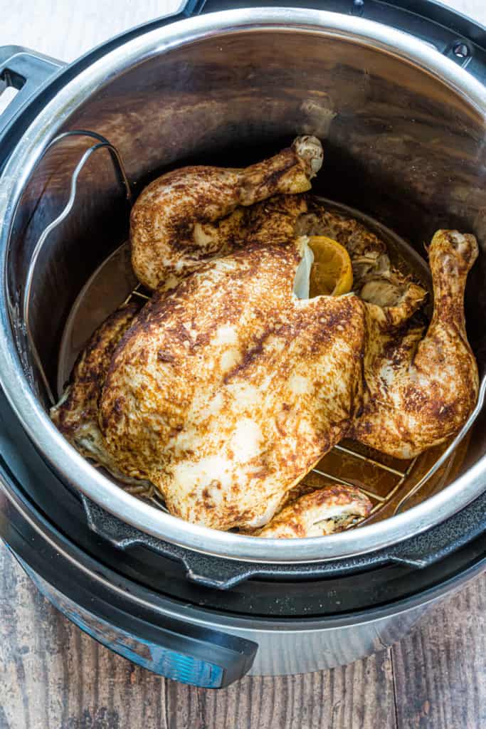 the finished whole chicken inside the instant pot insert