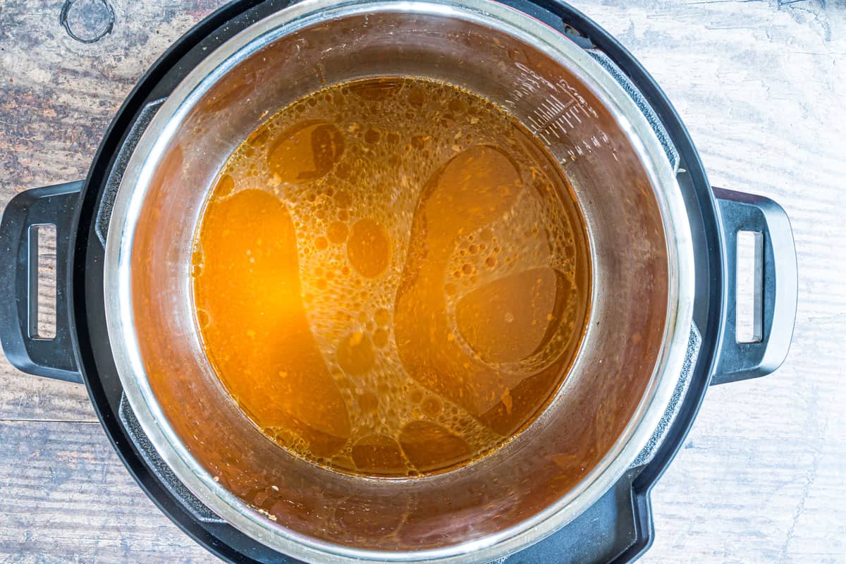 top down view of bone broth inside the instant pot insert and made from instant pot whole chicken