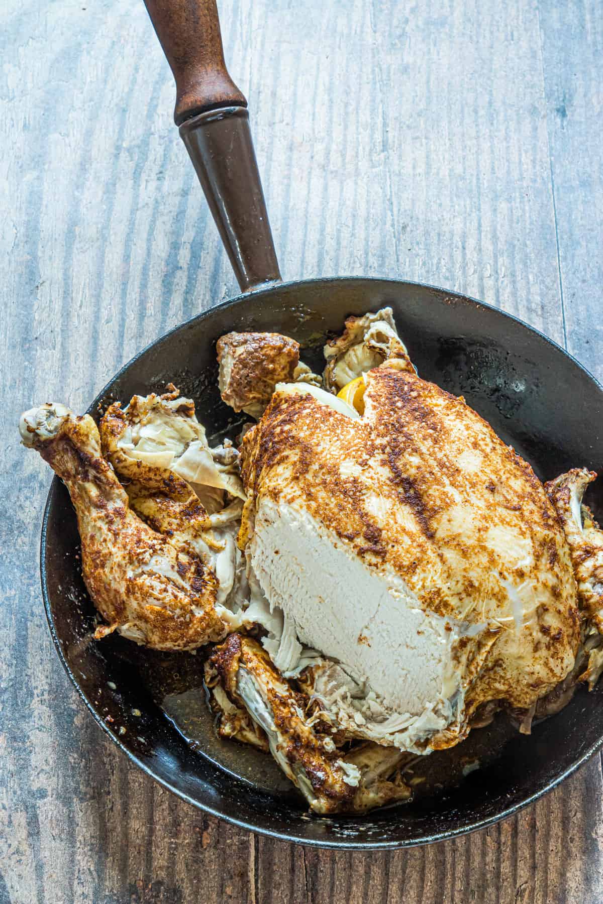 the completed whole chicken in a pan