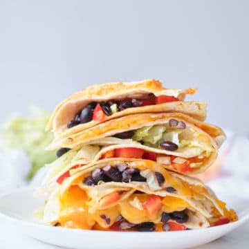 black bean quesadillas stacked on top of one another