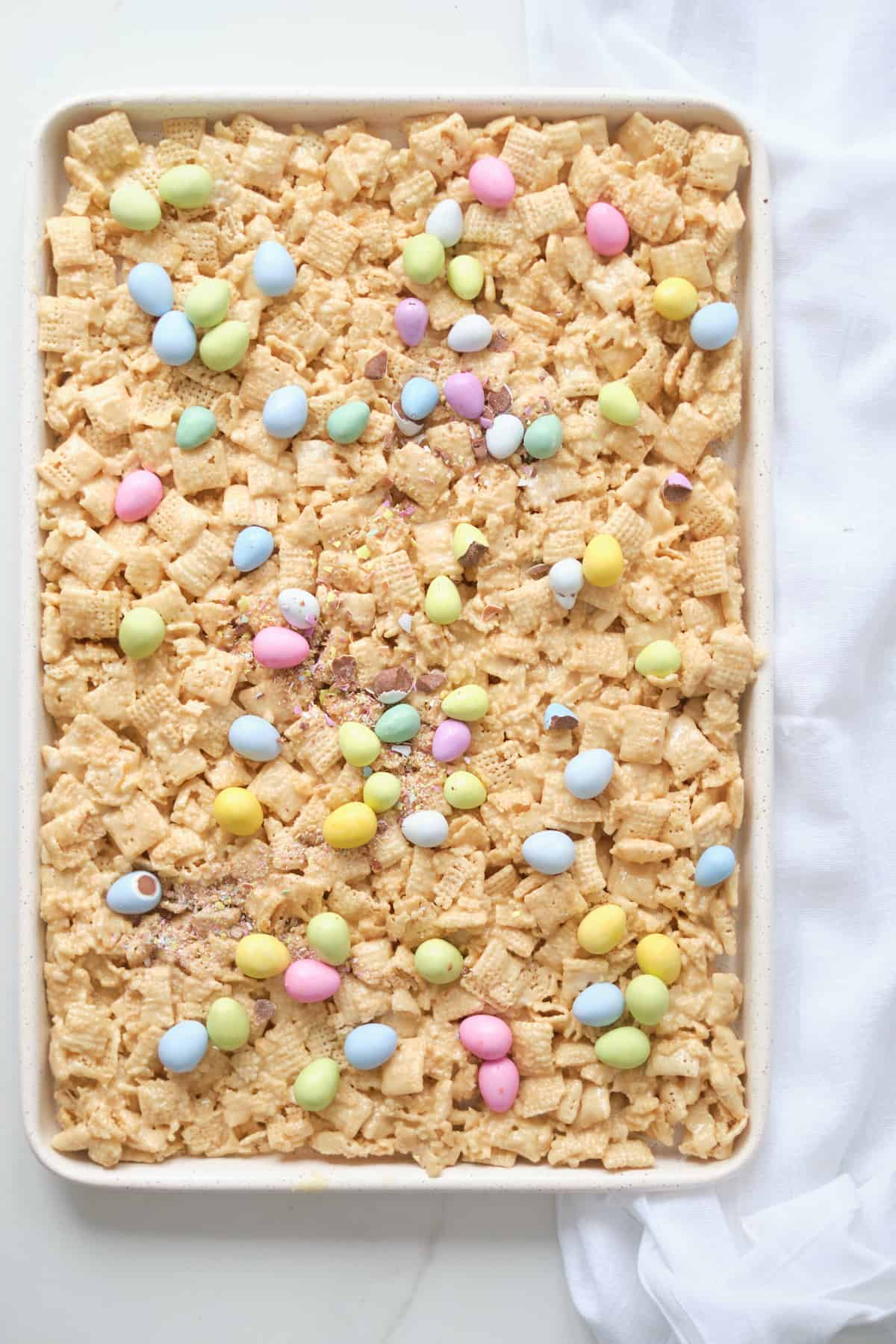 top down view of a baking sheet filled with the finished no bake chex bars and ready to cut into squares