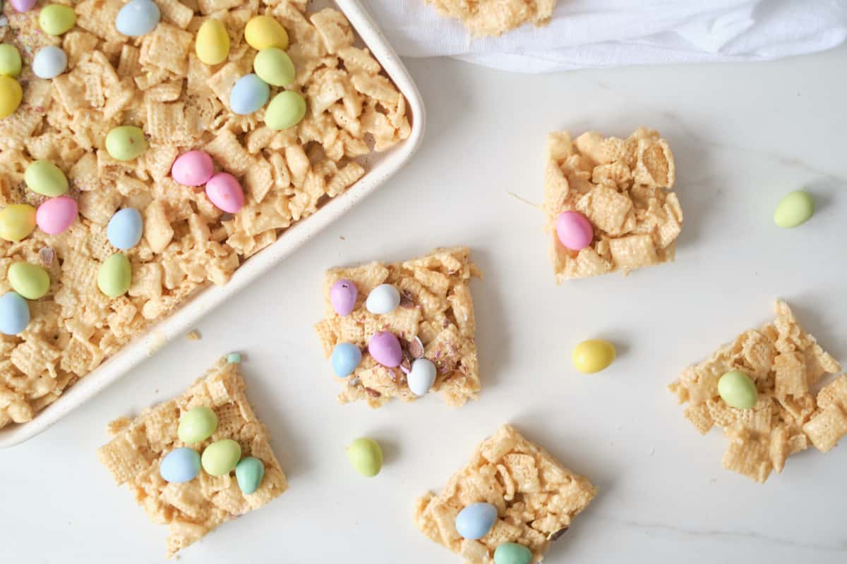 four of the finished Easter no bake chex bars on a countertop next to the baking tray