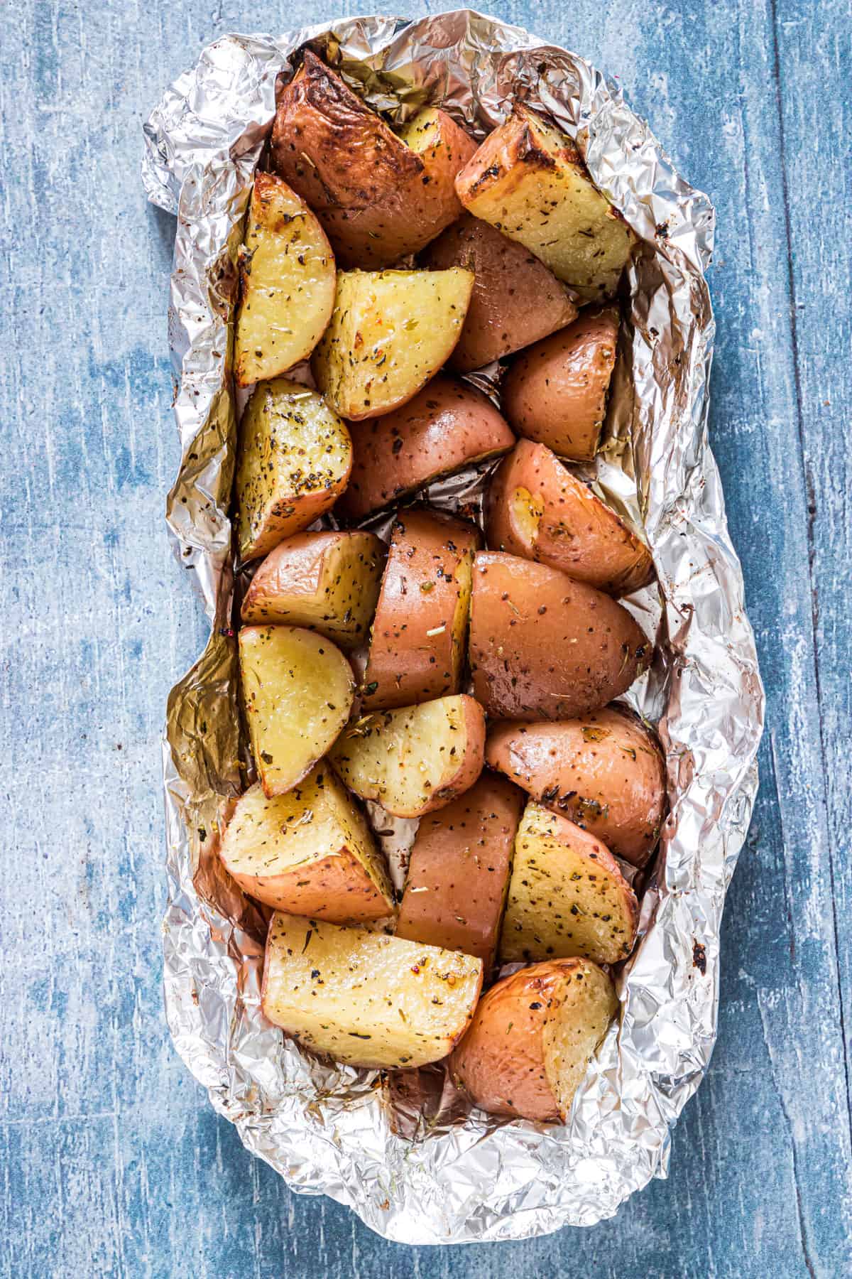 grilled Red potatoes in a foil packed on a table