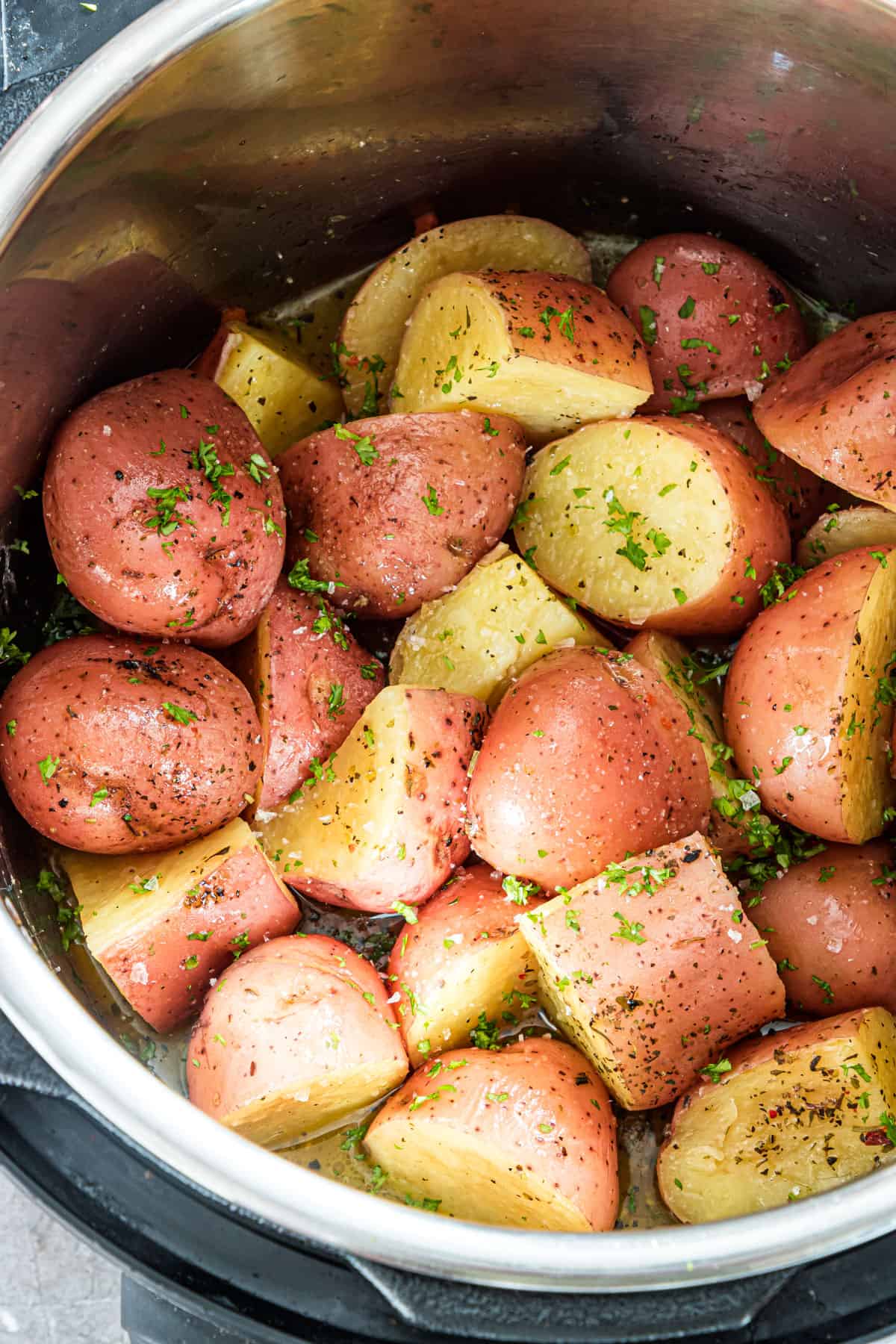 close up view of the garlic butter red potatoes inside the instant pot