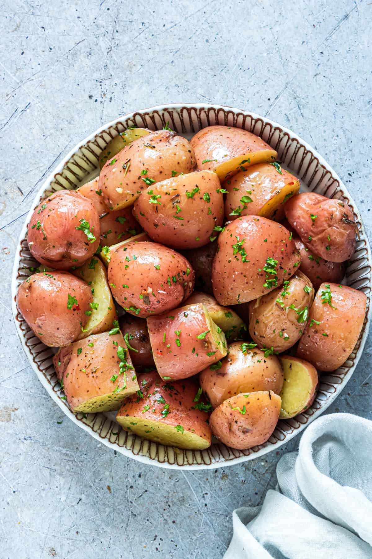 top down view of a ceramic bowl filled with Instant Pot Red Potatoes