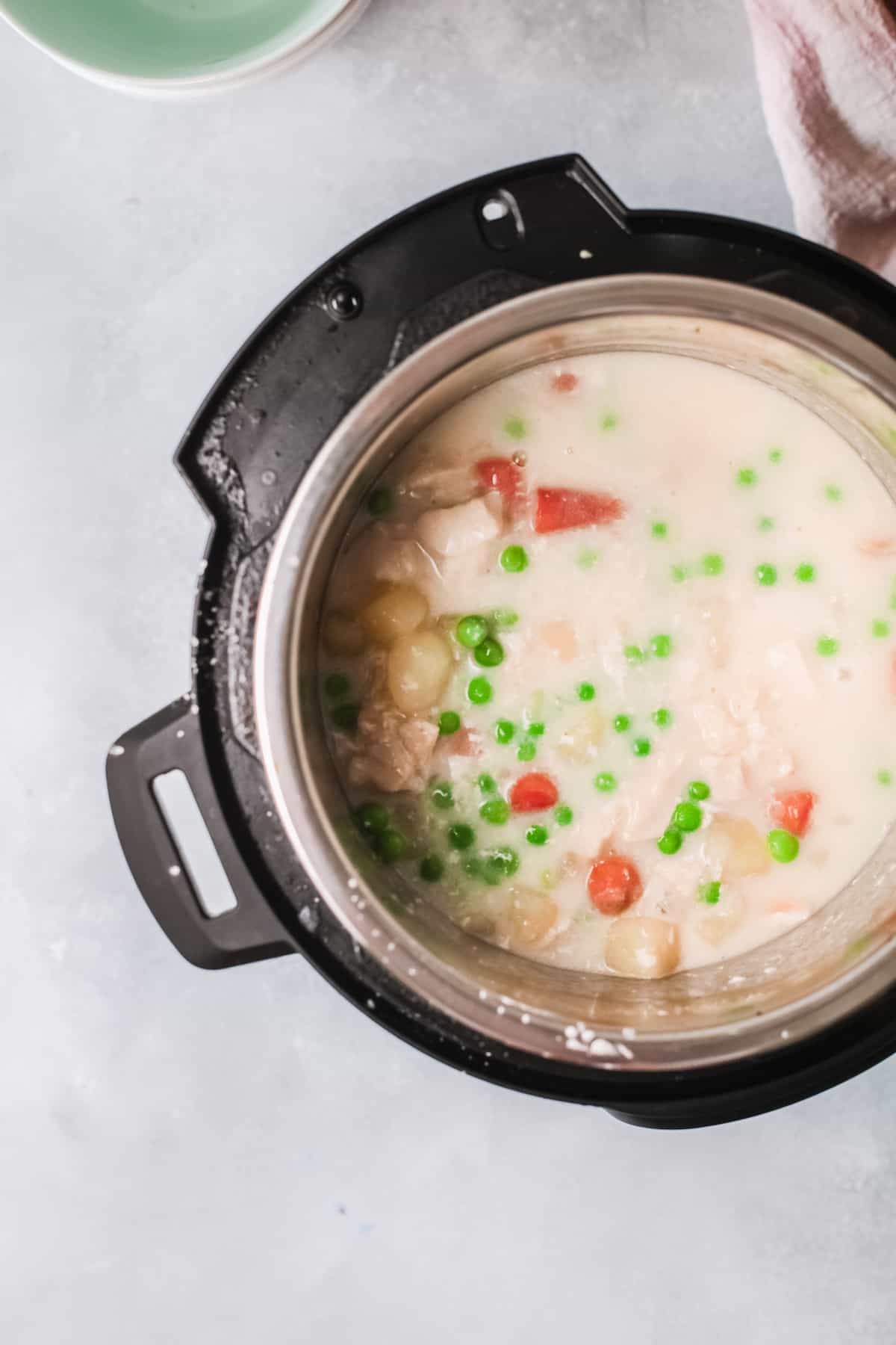 top down view of the cooked chicken pot pie soup inside the instant pot