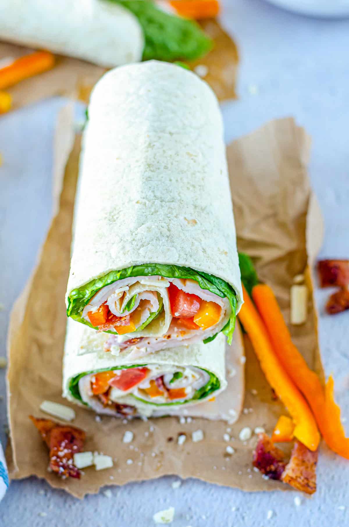 two halves of a chicken bacon ranch wrap stacked vertically and ready to be served