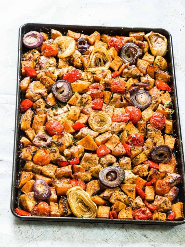 the sheet pan filled with cooked chicken and veggies