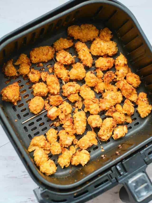 top down view of the cooked popcorn chicken inside the air fryer basket