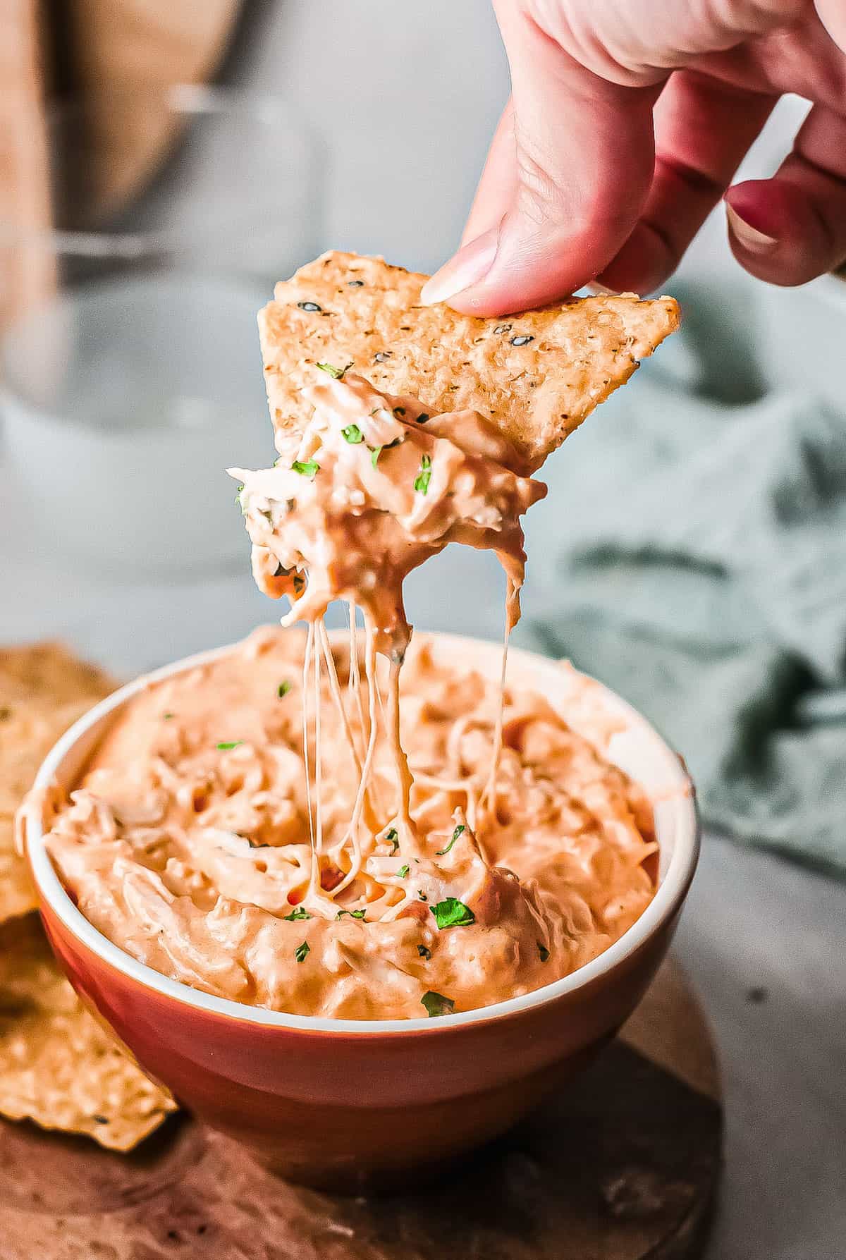 a chip scooping out some of the instant pot buffalo chicken dip