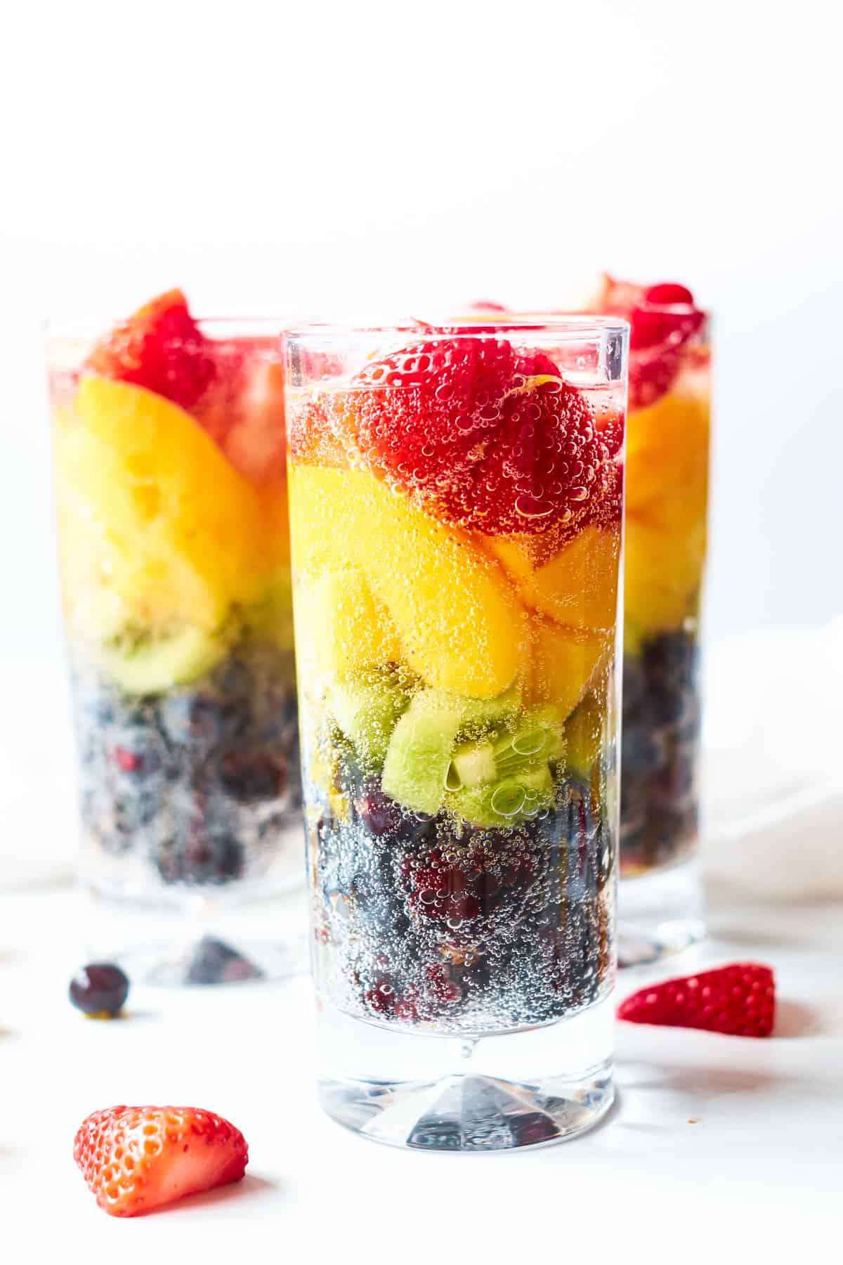 Rainbow Fruit Mocktail in a glass on a tabls