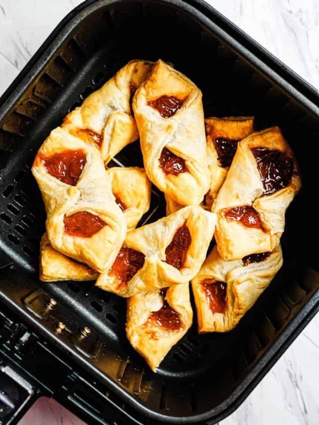 top down view of the cooked puff pastry breakfast bites inside the air fryer basket