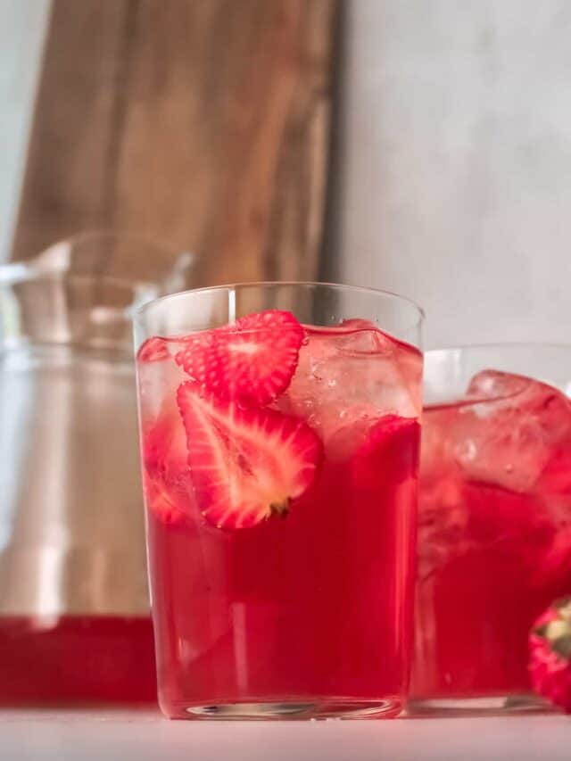 side view of two glasses filled with strawberry sweet tea