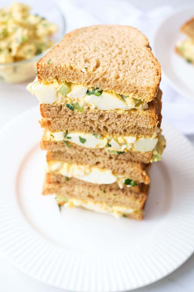 three-quarters view of a stack of completed Mexican Egg Salad Sandwiches