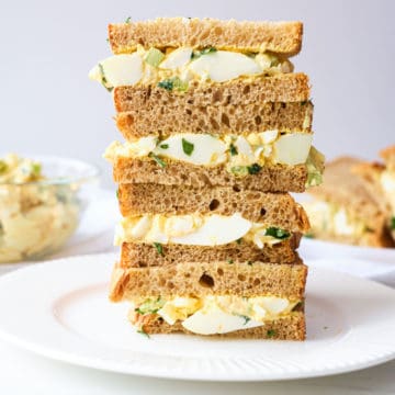 the finished egg salad sandwich halves stacked vertically