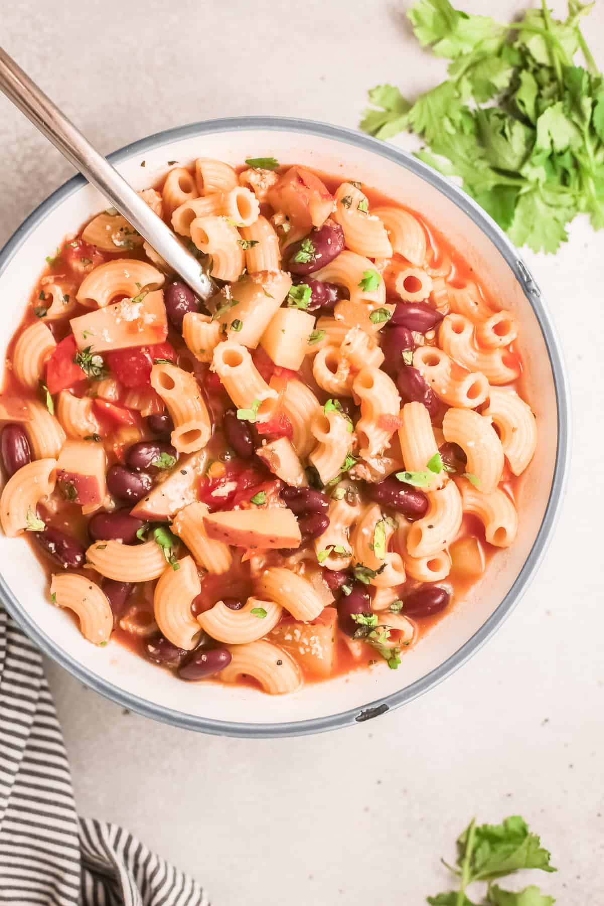 top down view of a bowl of the completed instant pot minestrone with a spoon inserted