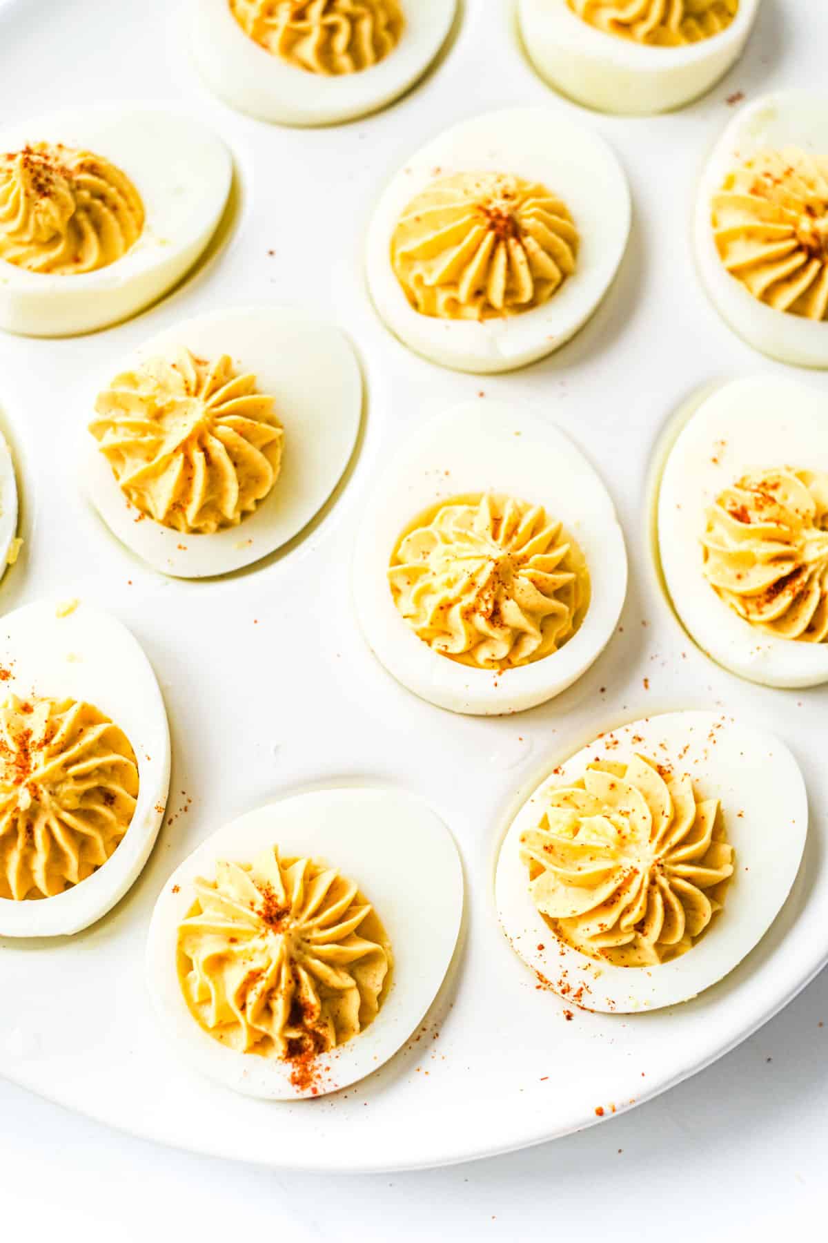 top down view of a plate filled with the finished mexican deviled eggs