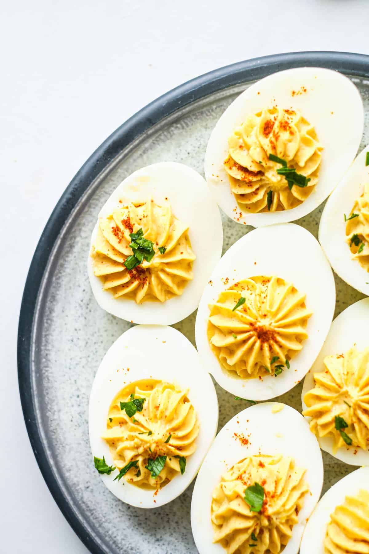 top down view of spicy deviled eggs on a plate