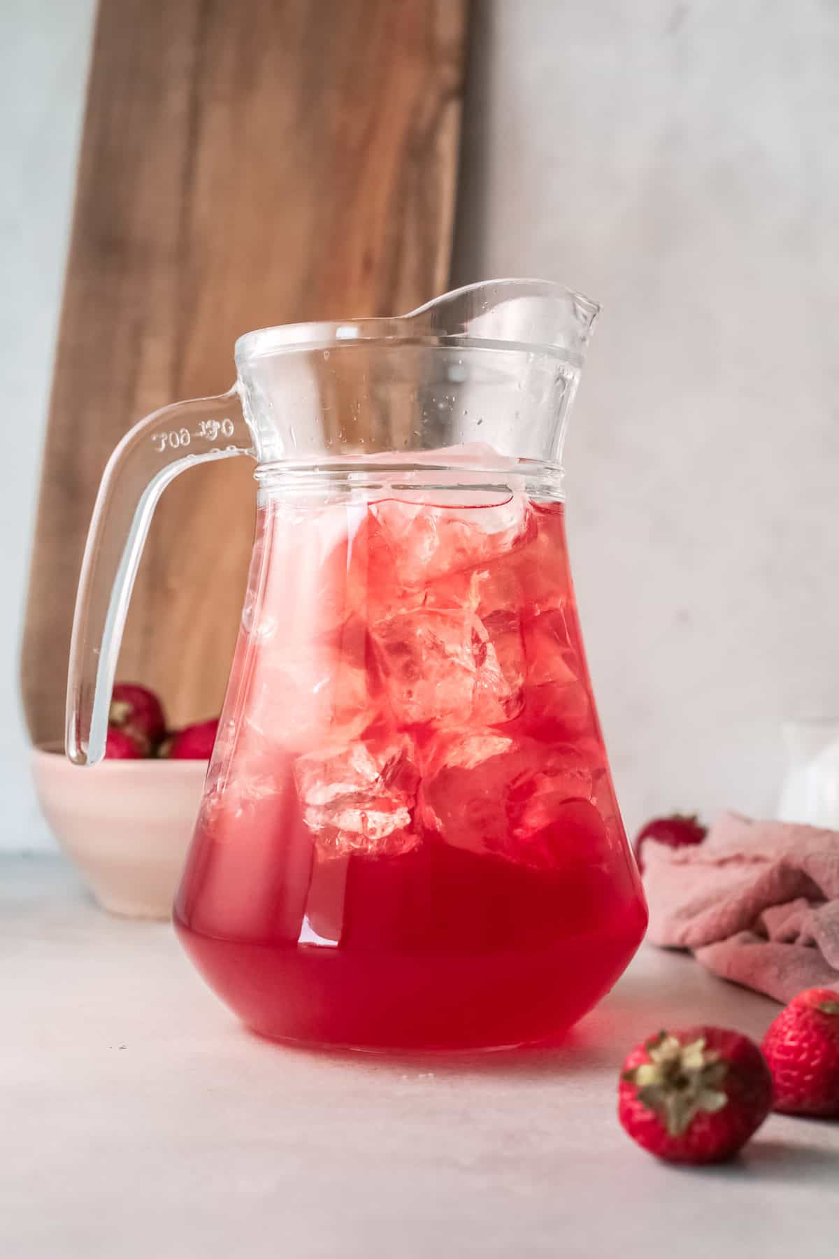 a pitcher filled with the finished strawberry sweet tea recipe