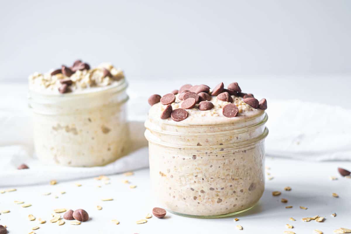 two servings of cookie dough overnight oats in small mason jars