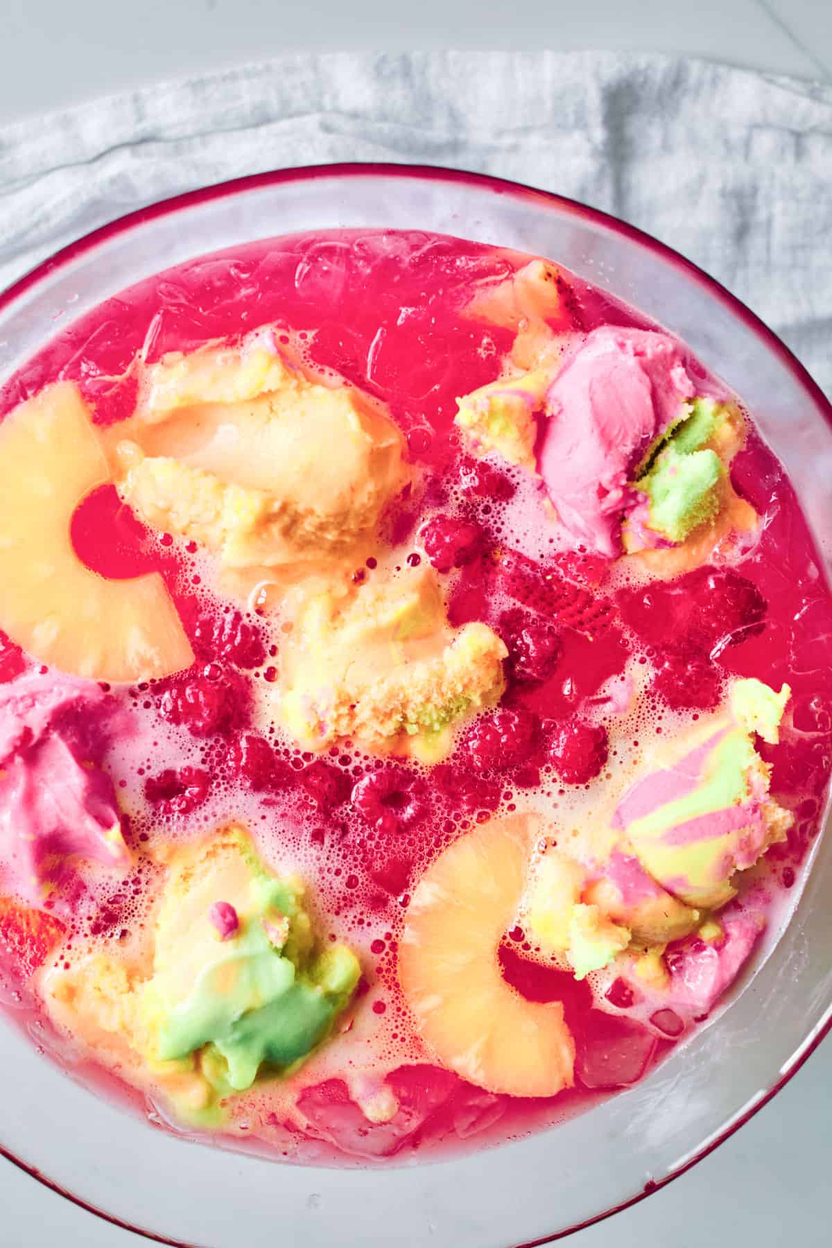 top down view of the rainbow sherbet punch in a glass punchbowl