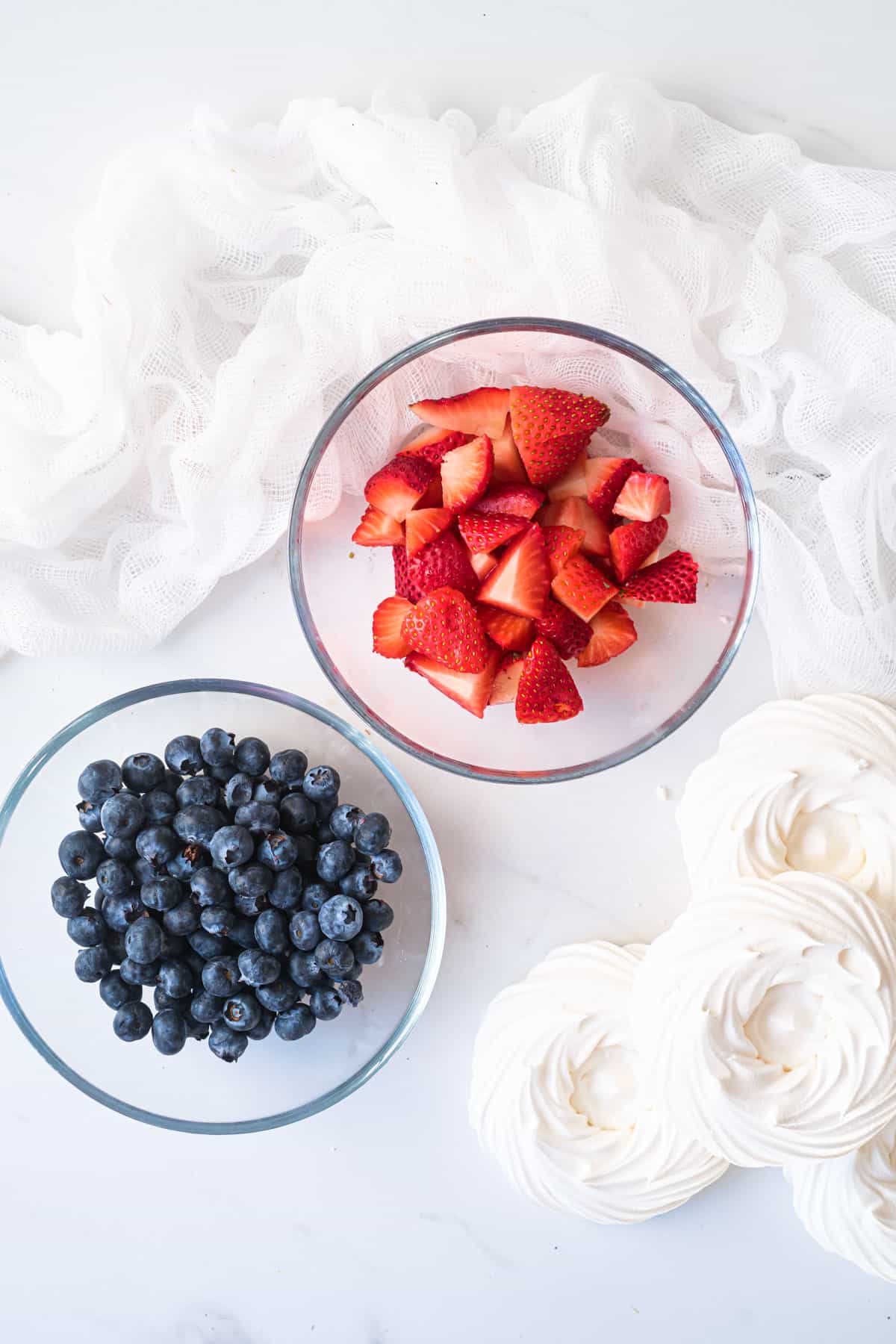 Mini Pavlovas and berries on a table