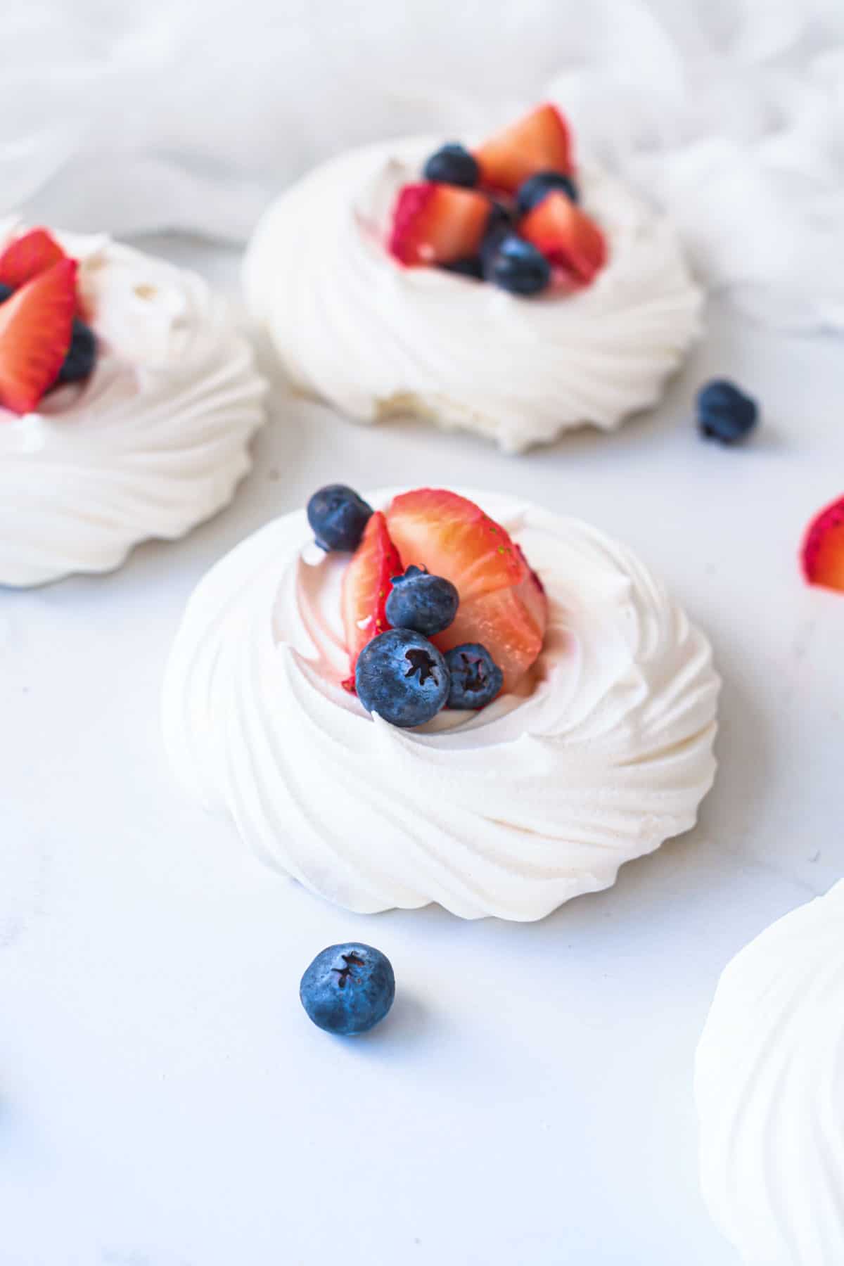 mini pavlovas filled with cream and fruit