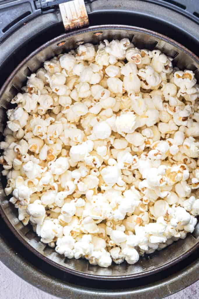 cooked air fryer popcorn in an air fryer basket