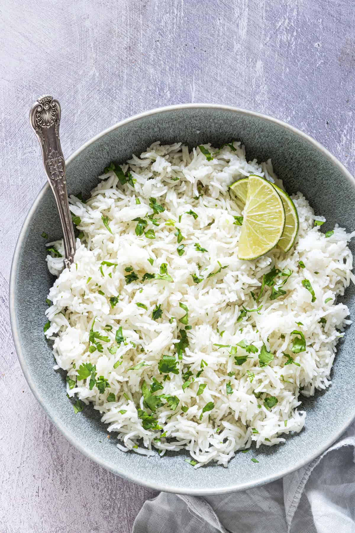 top down view of the finished Instant pot Cilantro Lime Rice served in a bowl with a silver serving spoon