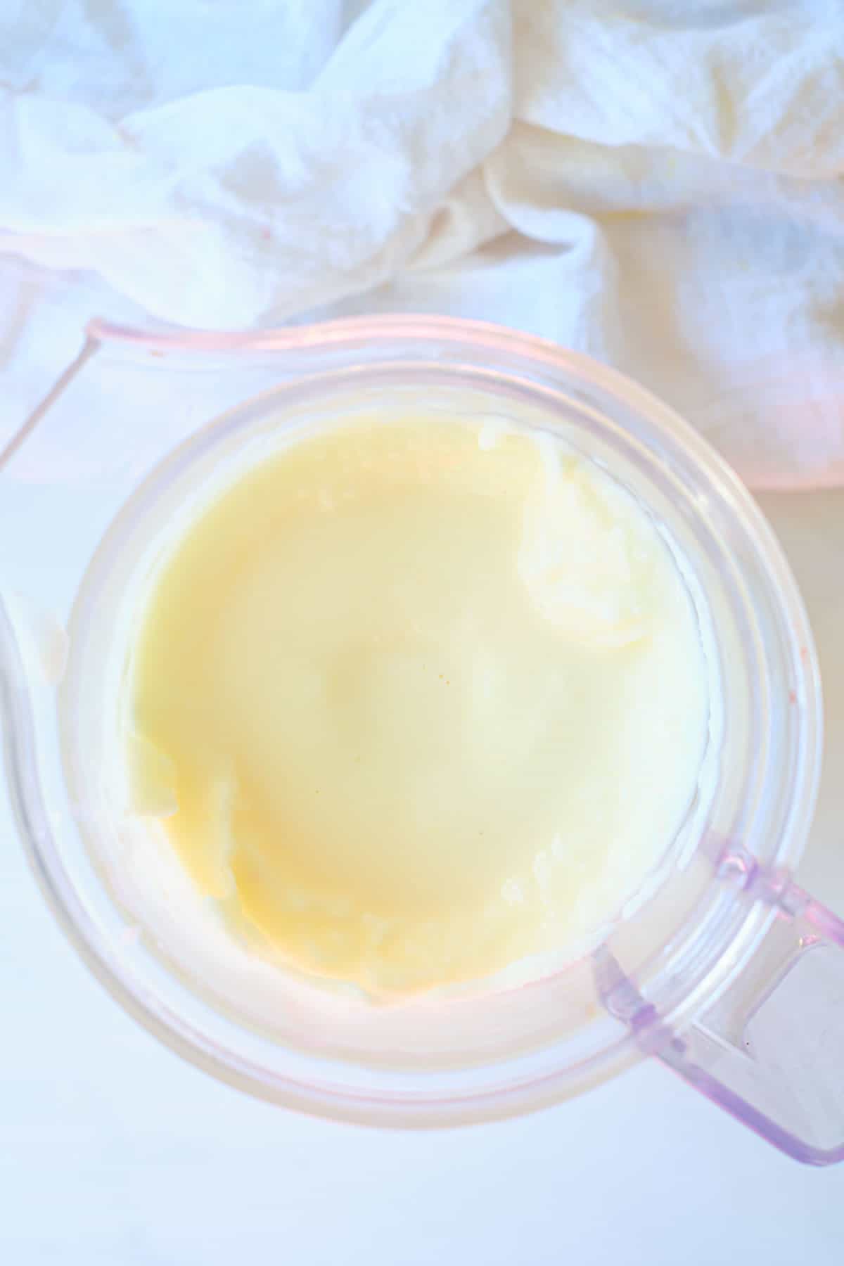 A blender showing frosted lemonade being made