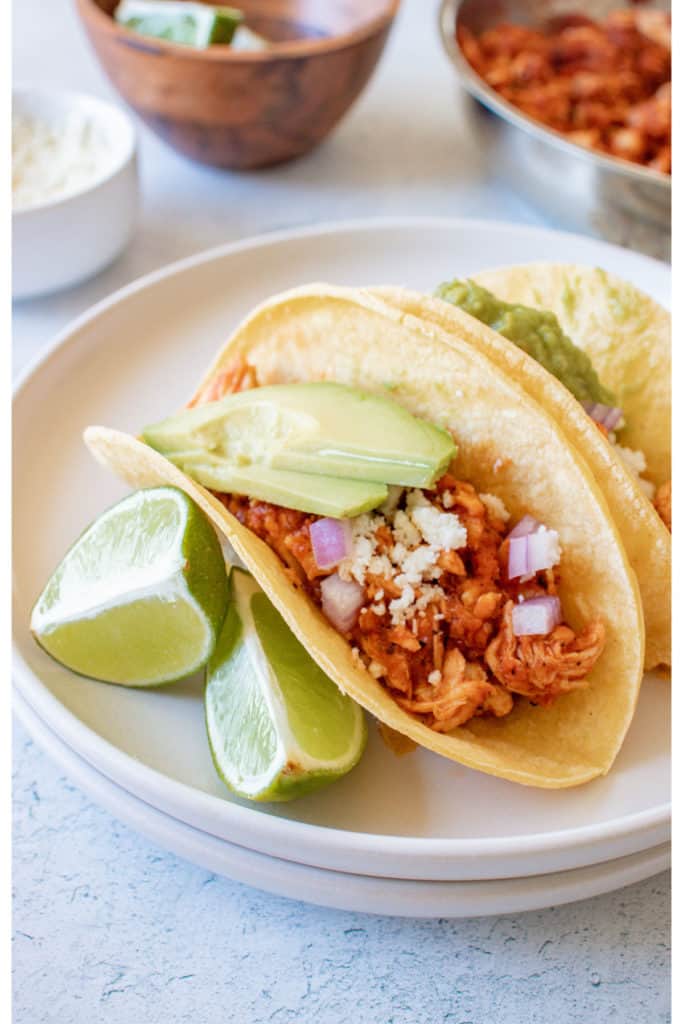 the completed chicken tinga tacos served on a white plate
