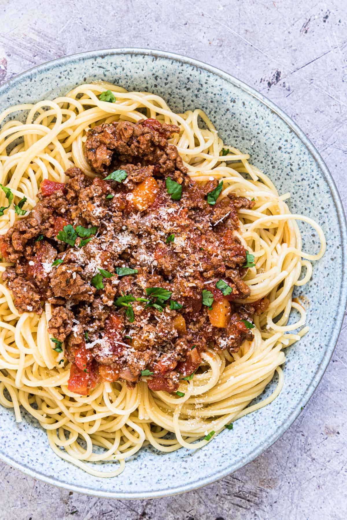 the finished instant pot bolognese sauce served on spaghetti noodles