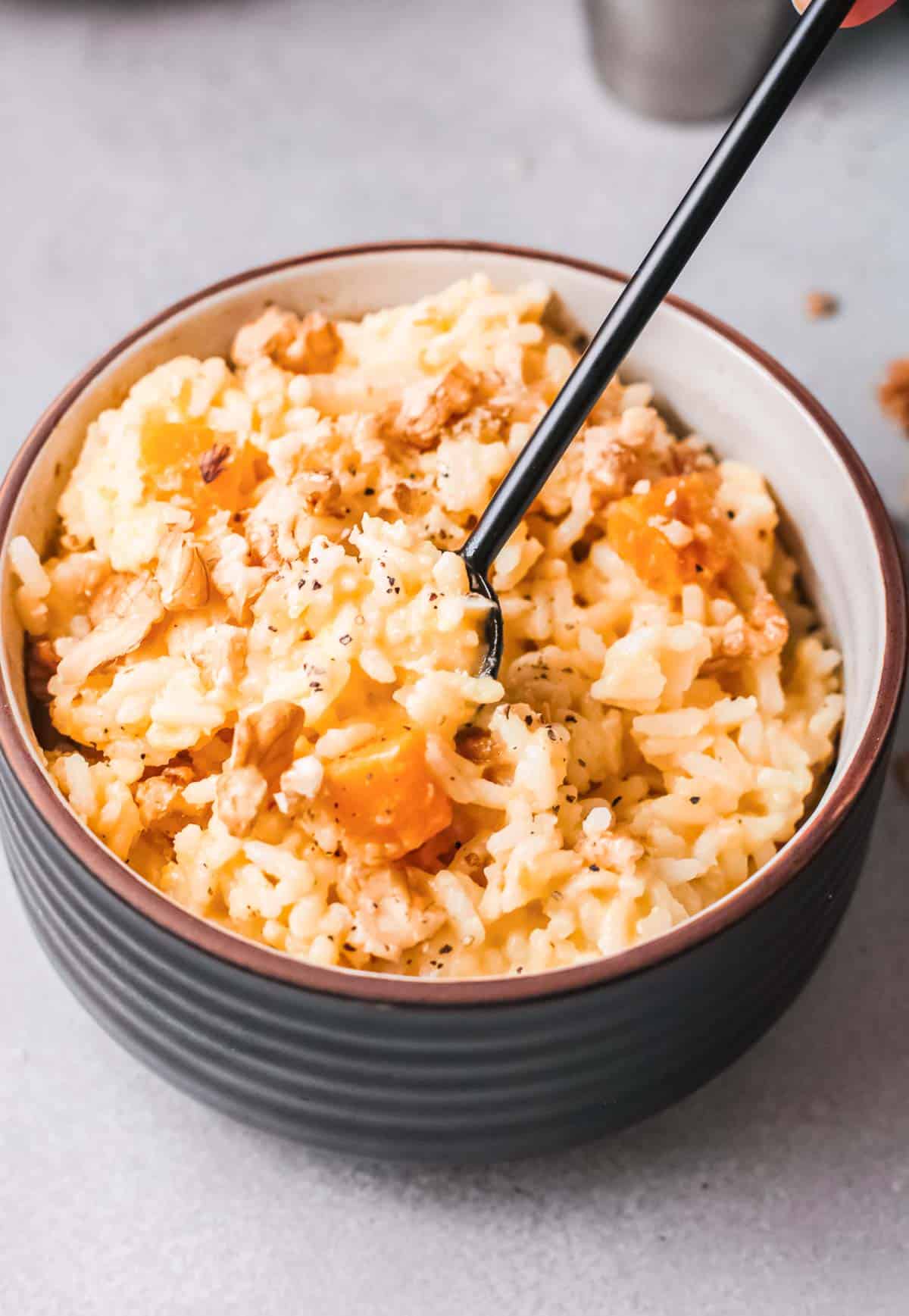 one bowl of instant pot pumpkin risotto served with a fork