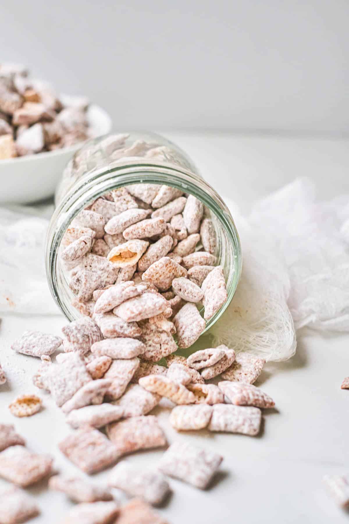 a jar with muddy buddies, puppy chow chex mix