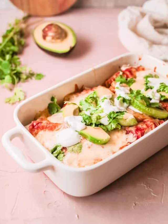 the completed slow cooker chicken enchiladas in a white serving dish