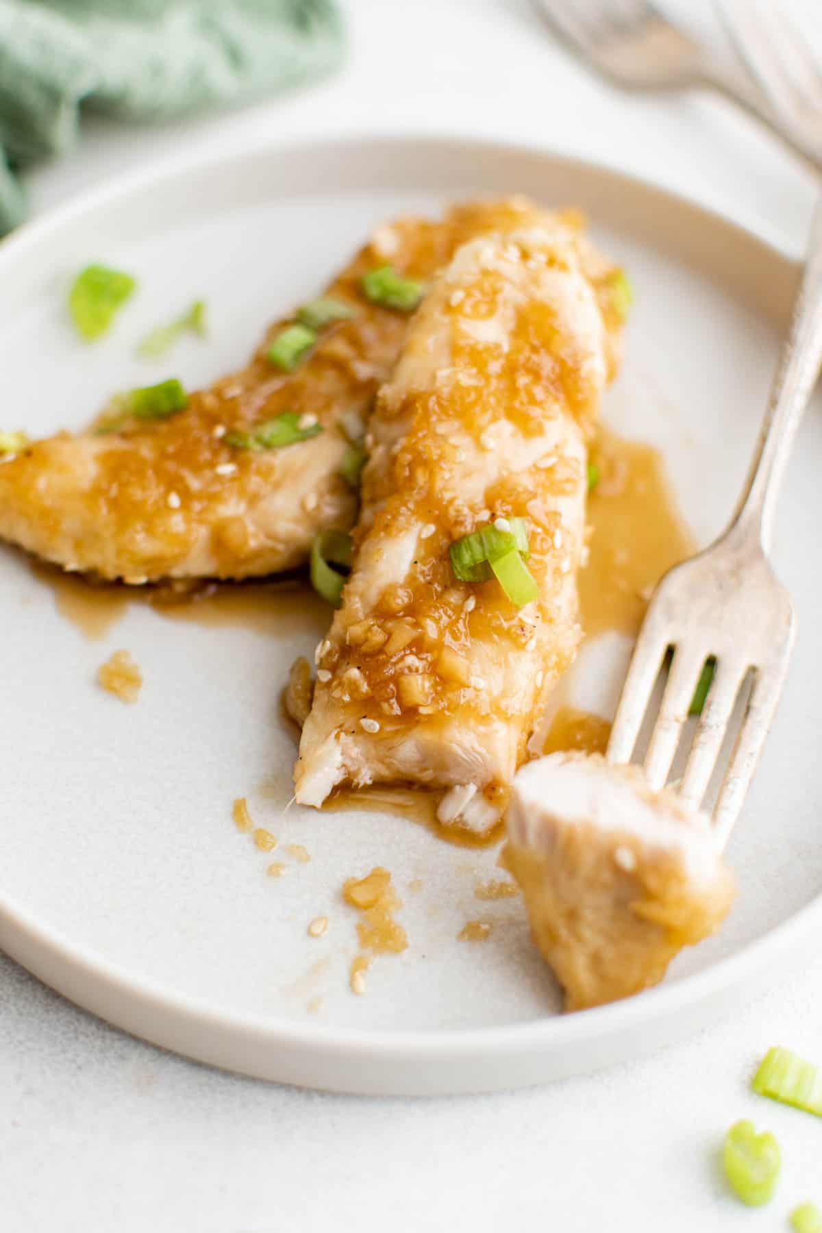 close up view of the finished honey garlic chicken tender recipe served on a white plate