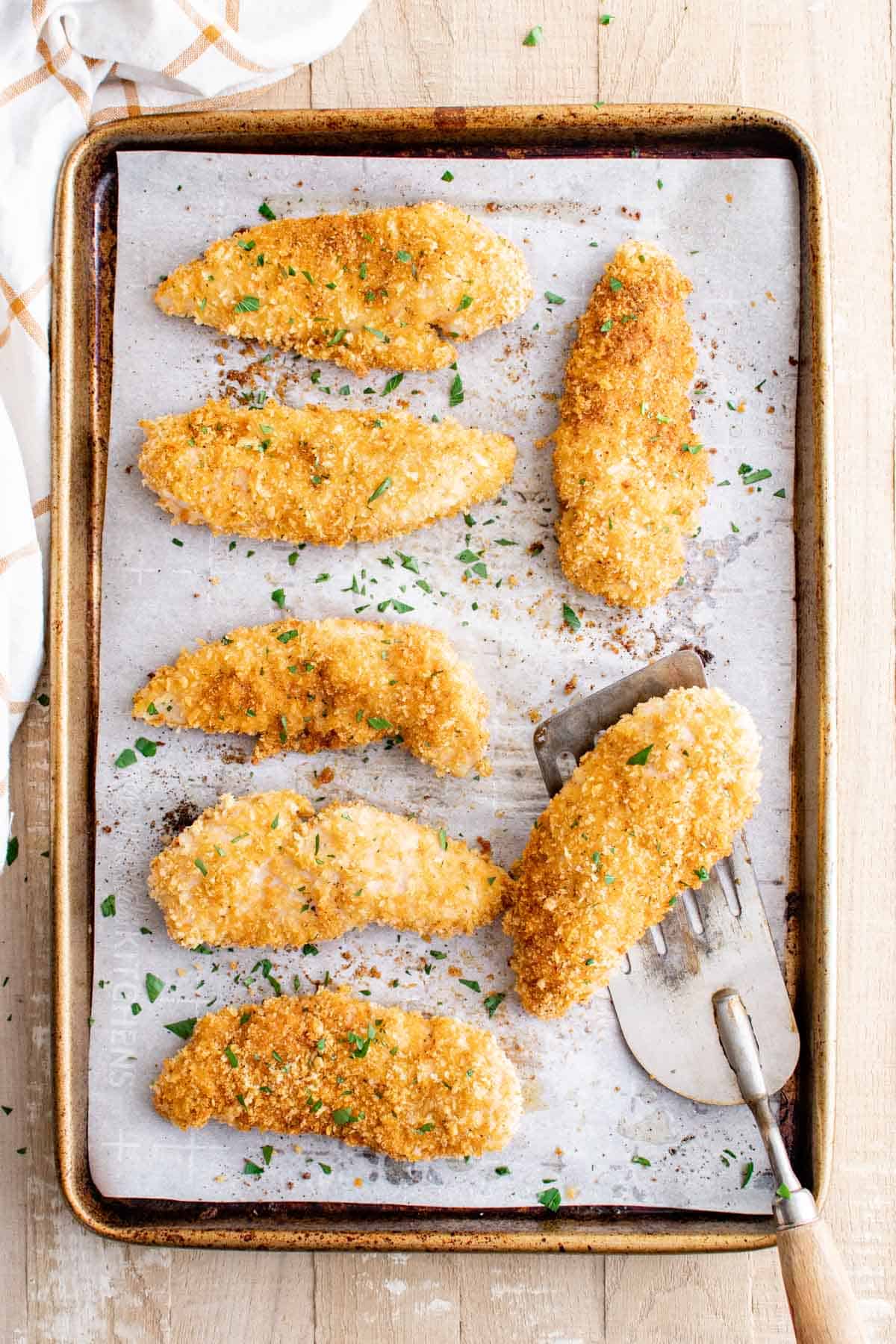 top down view of the completed baked chicken tenders on a baking tray