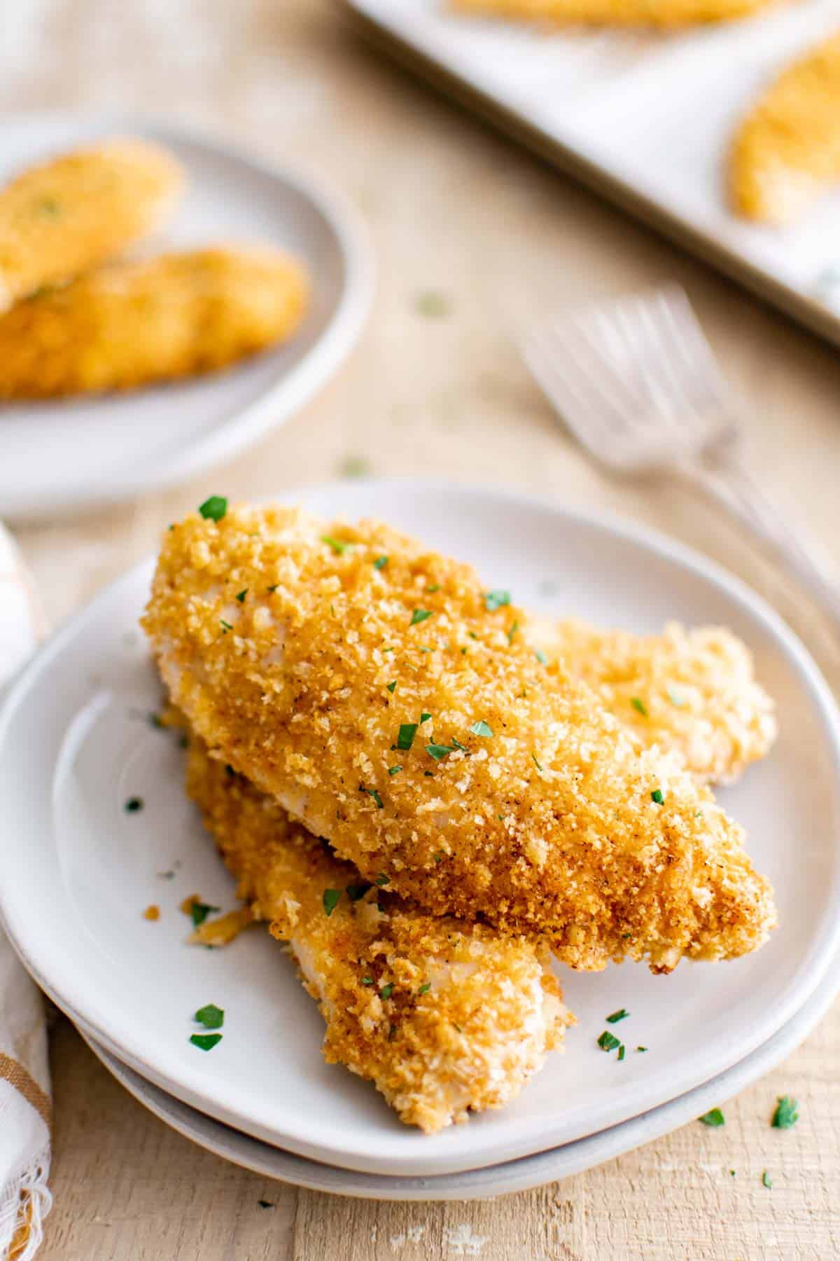 the finished baked chicken tenders served on a white plate