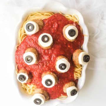 a serving platter filled with halloween spaghetti and meatballs