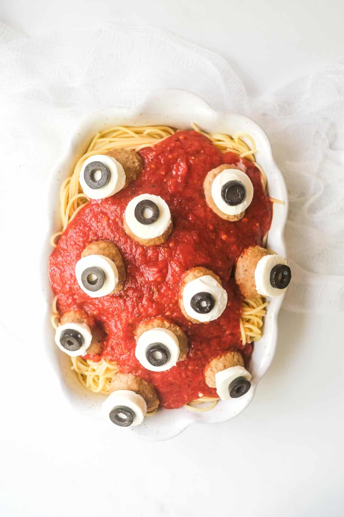 a serving platter filled with halloween spaghetti and meatballs