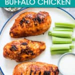 3 buffalo chicken breasts on a plate with celery and dressing