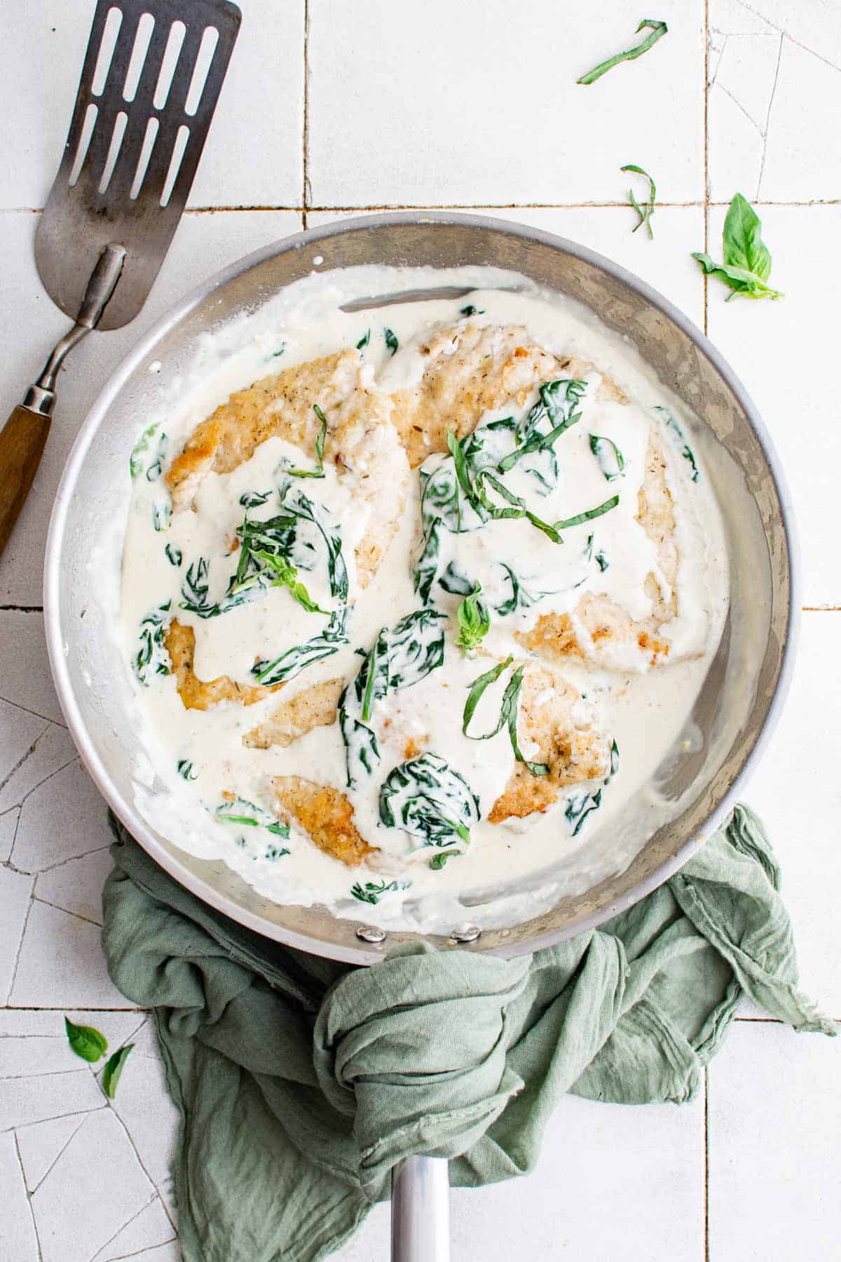 Creamy Chicken Florentine is a one-pot meal that’s great for weeknight dinner, date nights, or all sorts of special occasions. Lightly breaded chicken is pan-seared and cooked with a delectable white wine sauce loaded with parmesan cheese, garlic, and fresh spinach. Learn how to make chicken florentine and take your dinners from boring to exciting in less than 45 minutes. Click through to get this awesome chicken florentine recipe!! #chickenflorentine #onepot #fancychicken #easychickenrecipes"
